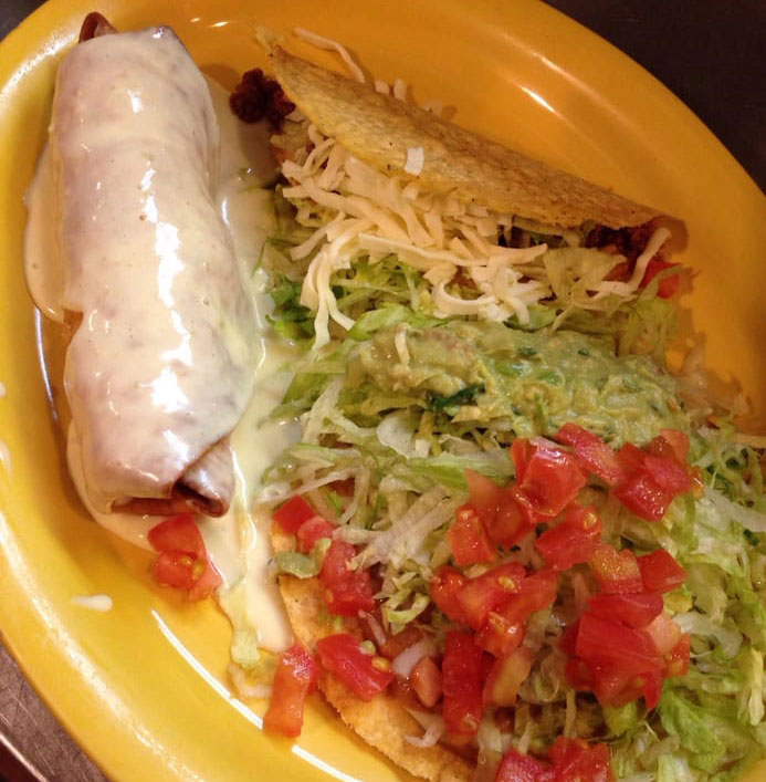 smothered burrito with taco and sides